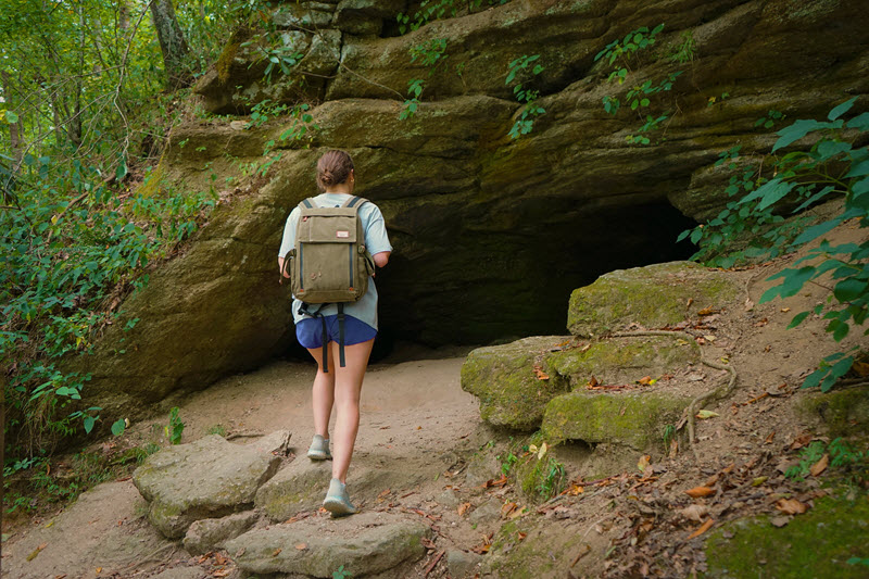 Hiker approaches cave opening