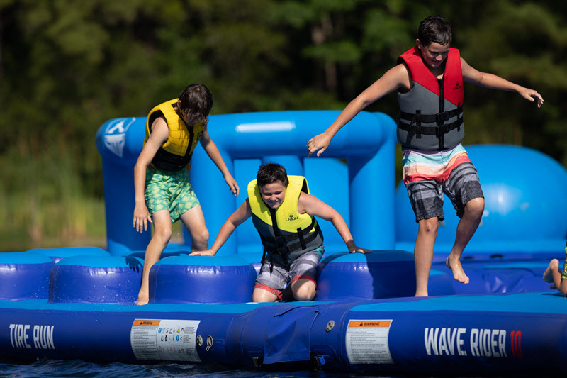 Boys play on water obstacle course at Charleston Aqua Park