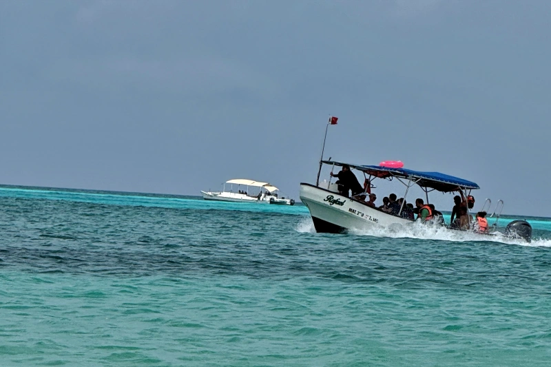 Snorkel tour boat crossing azure seas in Cozumel.